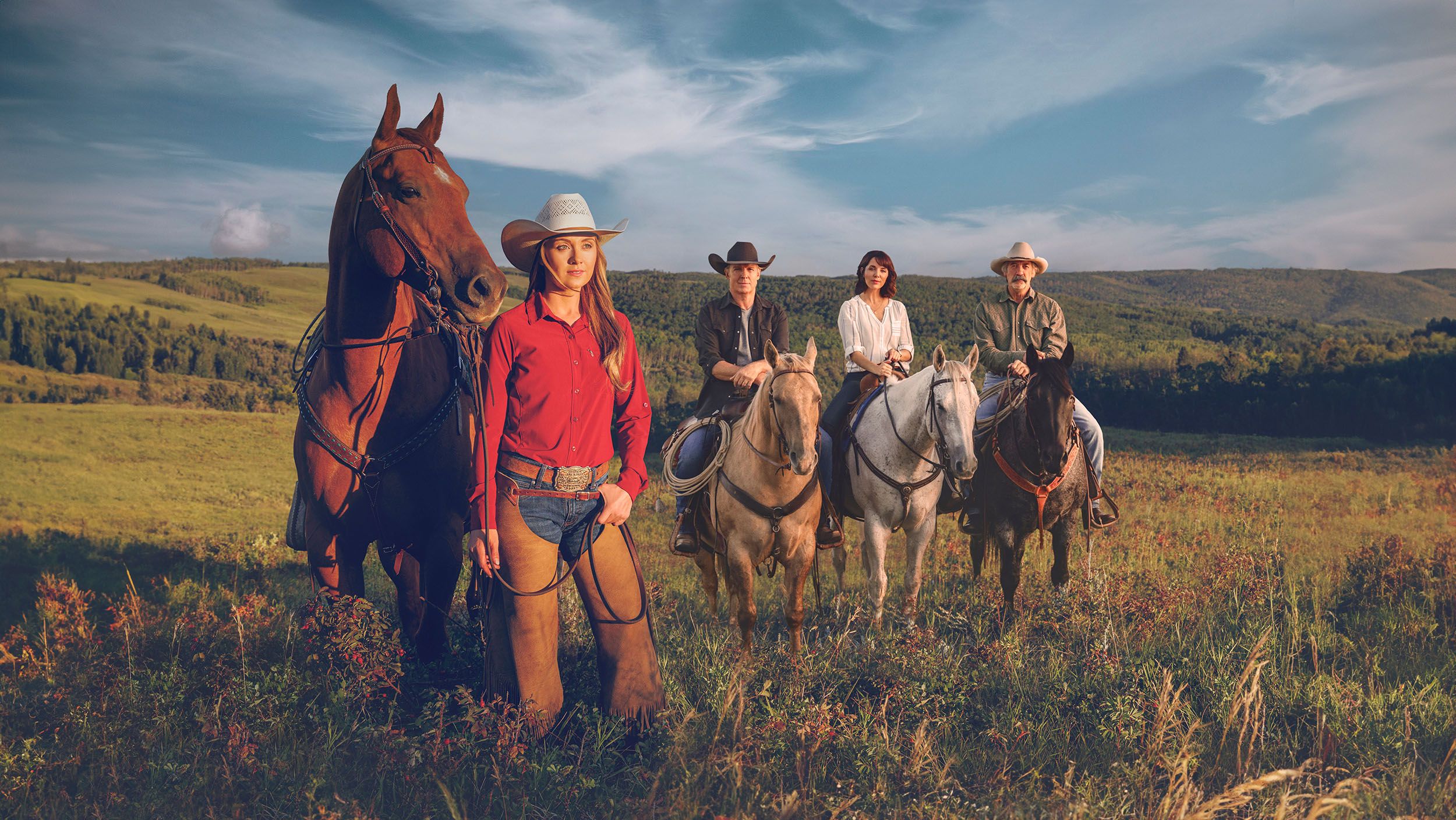 Cast of CBC's Heartland standing in the Foothills of Alberta.