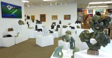 Interior of a gallery filled with rock sculptures.