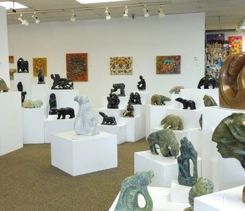 Interior of a gallery filled with rock sculptures.