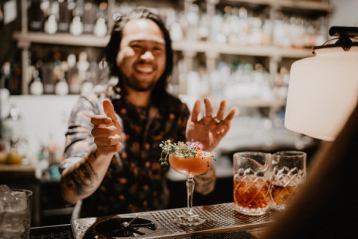 Bartender serving craft cocktails at a restaurant and bar