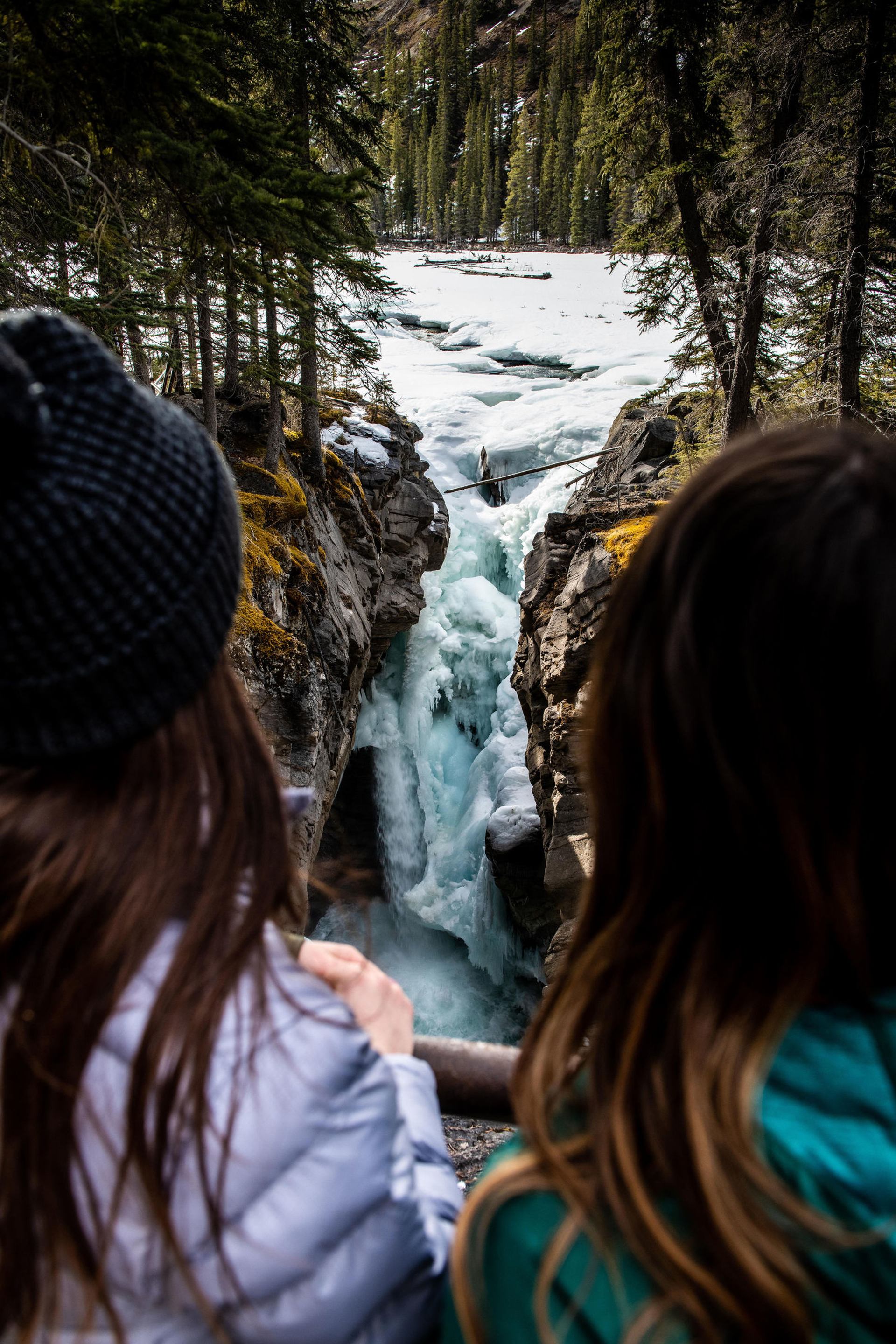 People in front of the frozen waterfall at Siffleur Falls in Nordegg