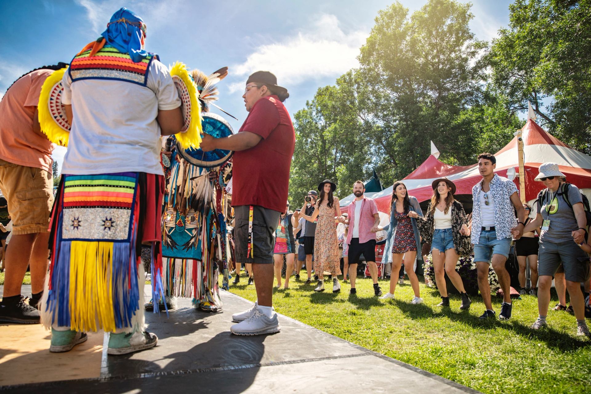 People enjoying an Indigenous program at a Festival.