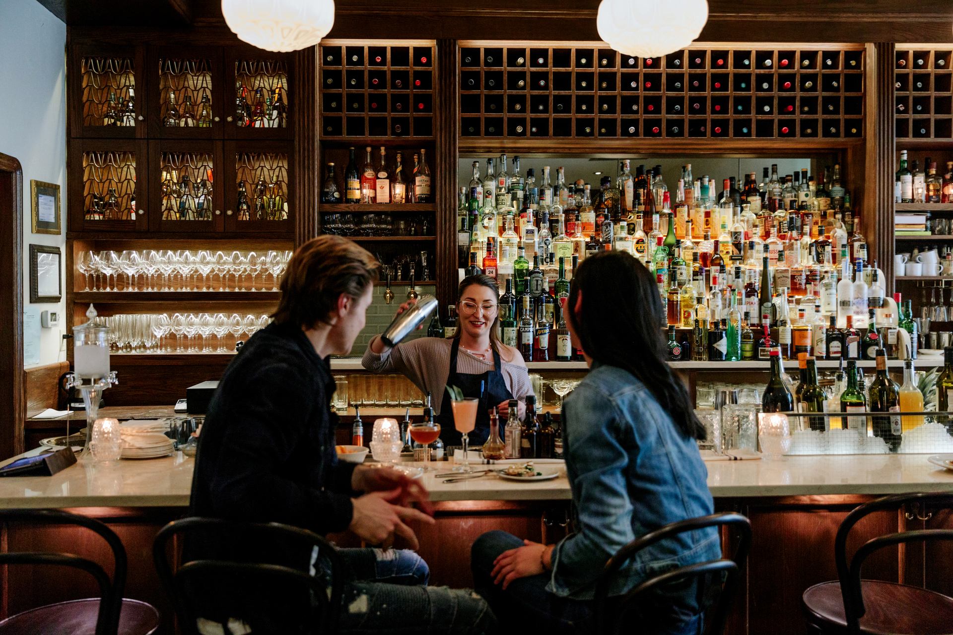 A couple enjoys craft cocktails at Bar Clementine in downtown Edmonton.