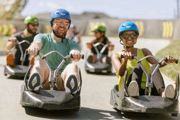 People riding the Skyline Luge at WinSport