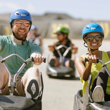People riding the Skyline Luge at WinSport