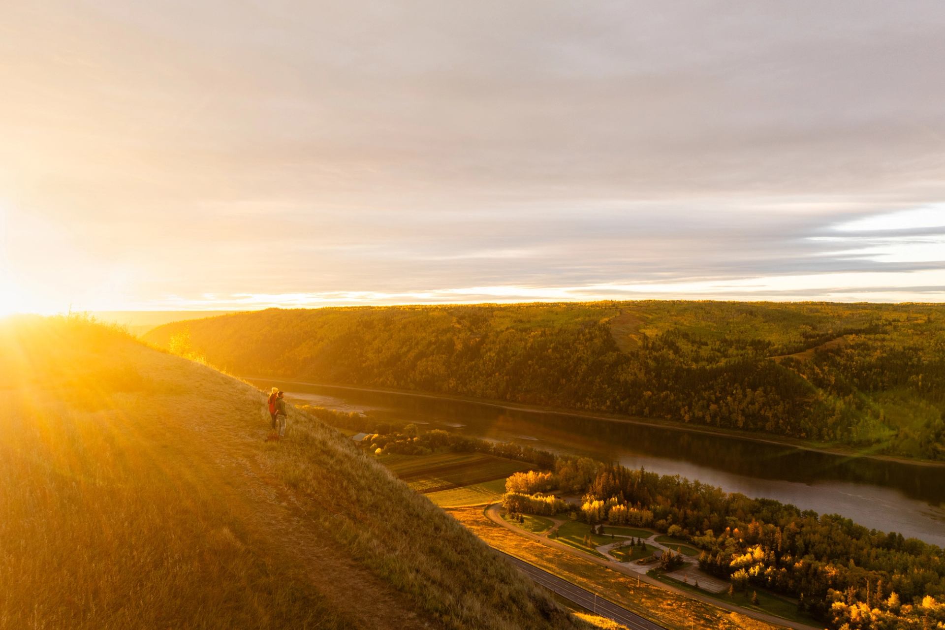 Aerial view of the sun shining on a family after hiking to the top of Dunvegan Overlook to watch sunrise together
