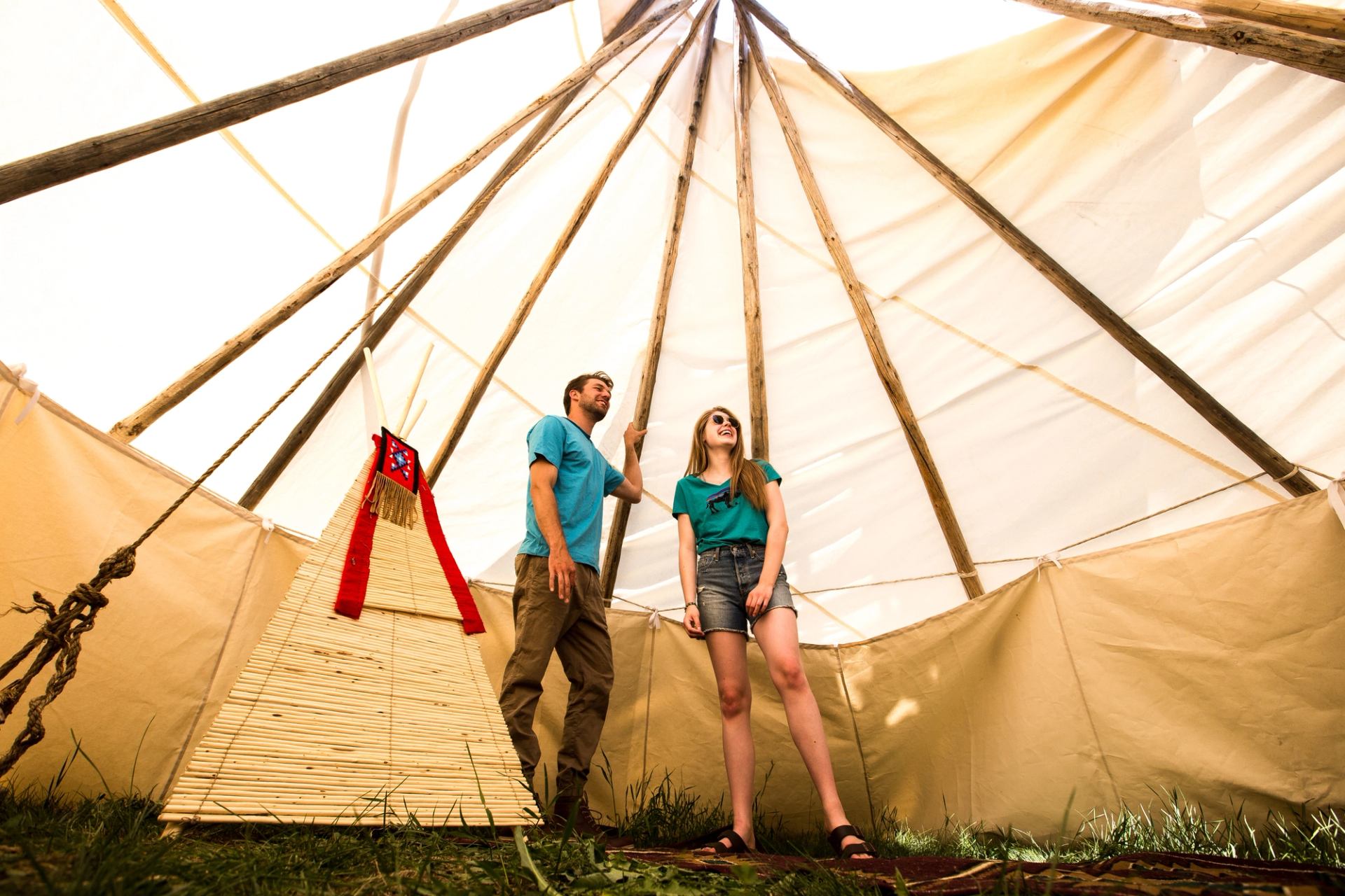 Couple inside a tipi at River Ranche Lodge.