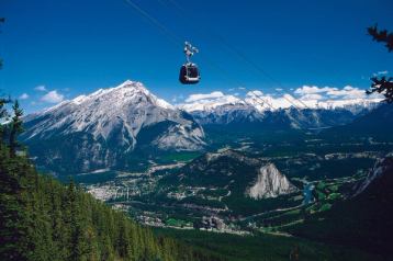 A gondola above mountain scenery.