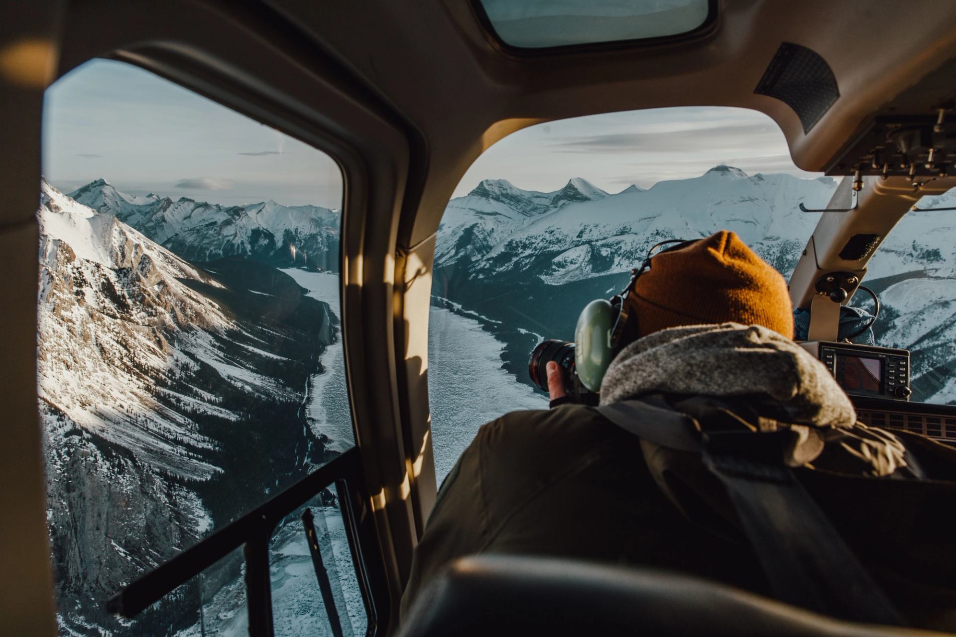 Visitor taking photos over Spray Valley while on a helicopter tour.