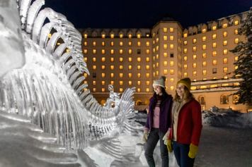 Two ladies looking at an ice sculpure.