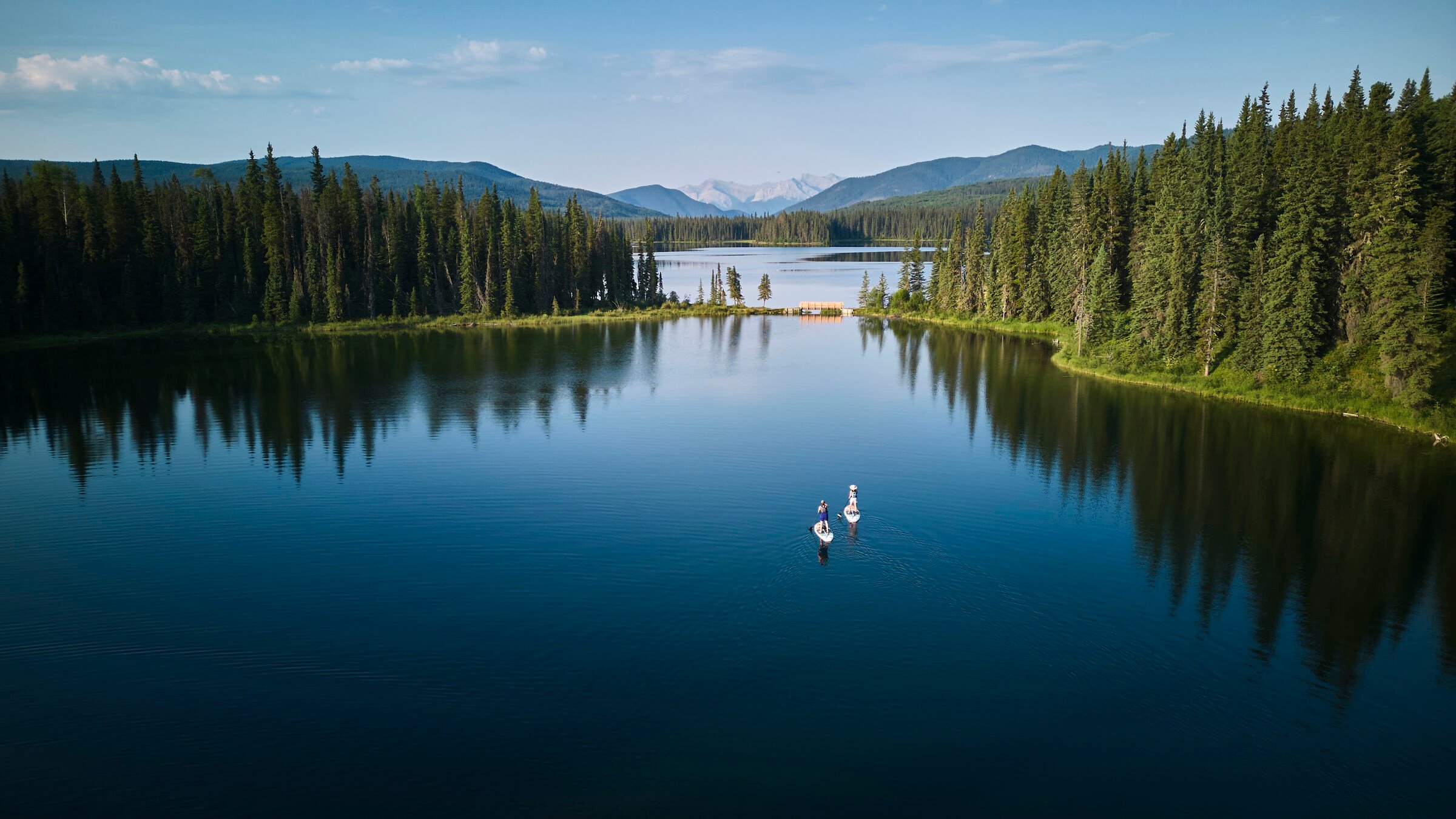 Aerial of two people standup paddle boarding (SUP) in Kelley's Bathtub, Northern Rockies, William A. Switzer Provincial Park.