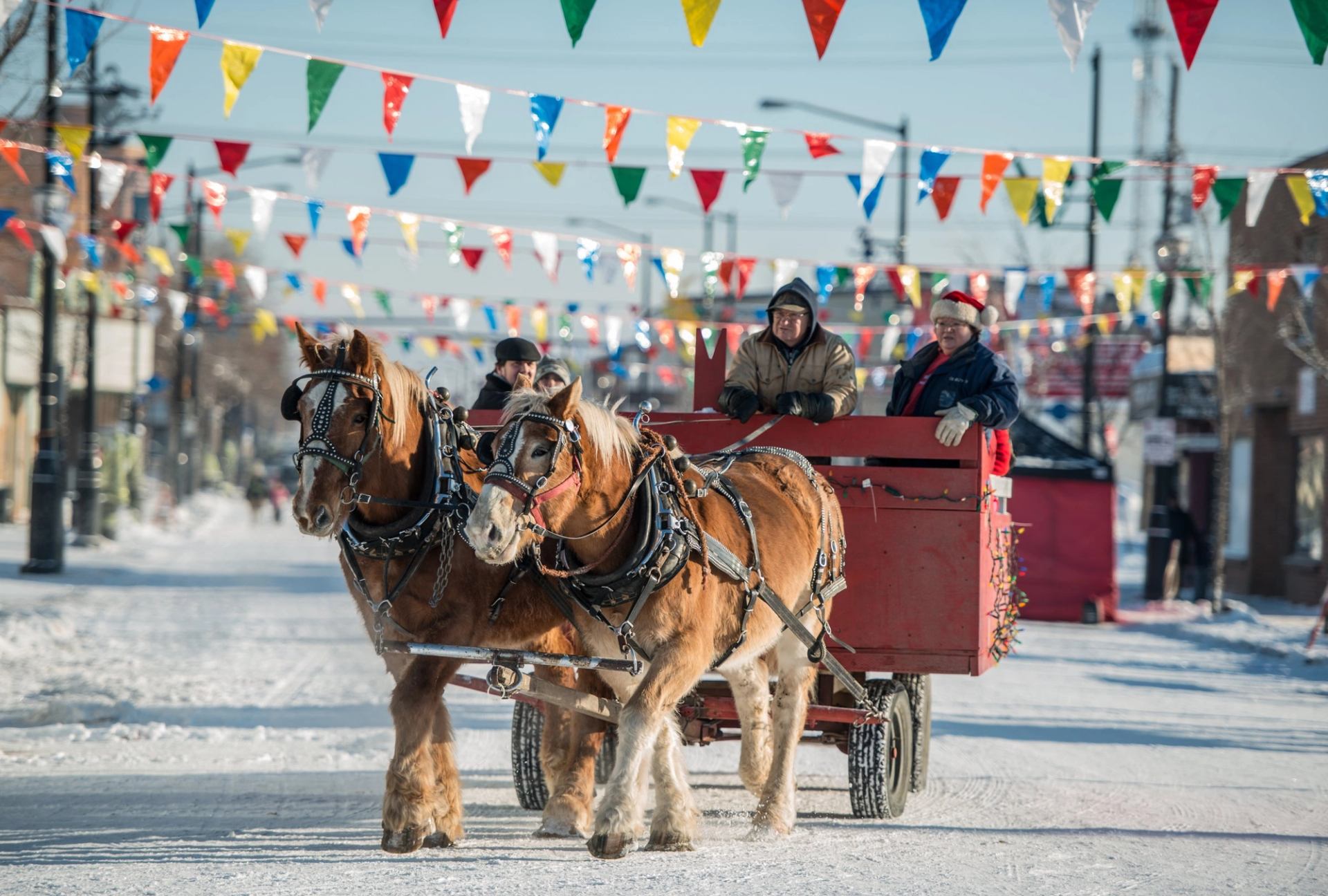 People being pulled in a horse drawn sleigh.