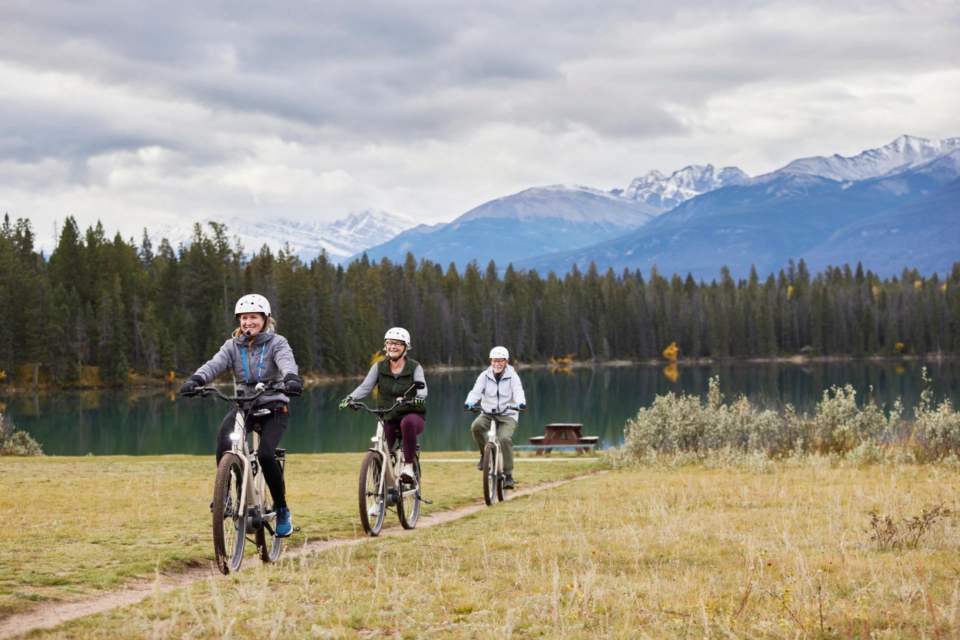 A guided e-bike tour in Jasper National Park in front of a lake