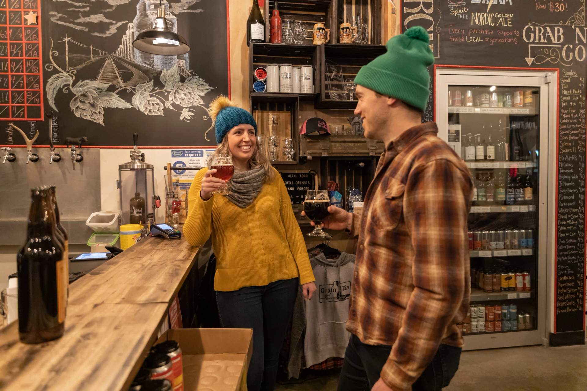 Man and woman enjoying a beverage at the bar at Grain Bin Brewing Company in Grande Prairie.