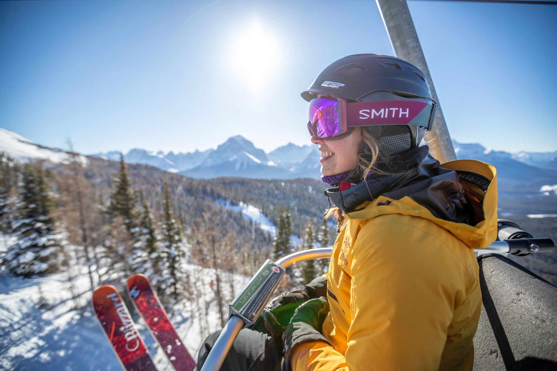 Skier on chairlift before skiing at Lake Louise Ski Resort.