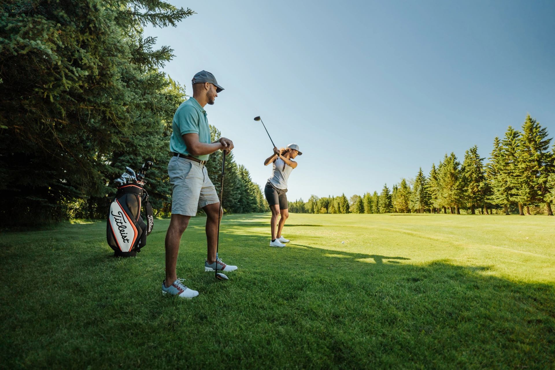 Couple golfing at Alberta country club.