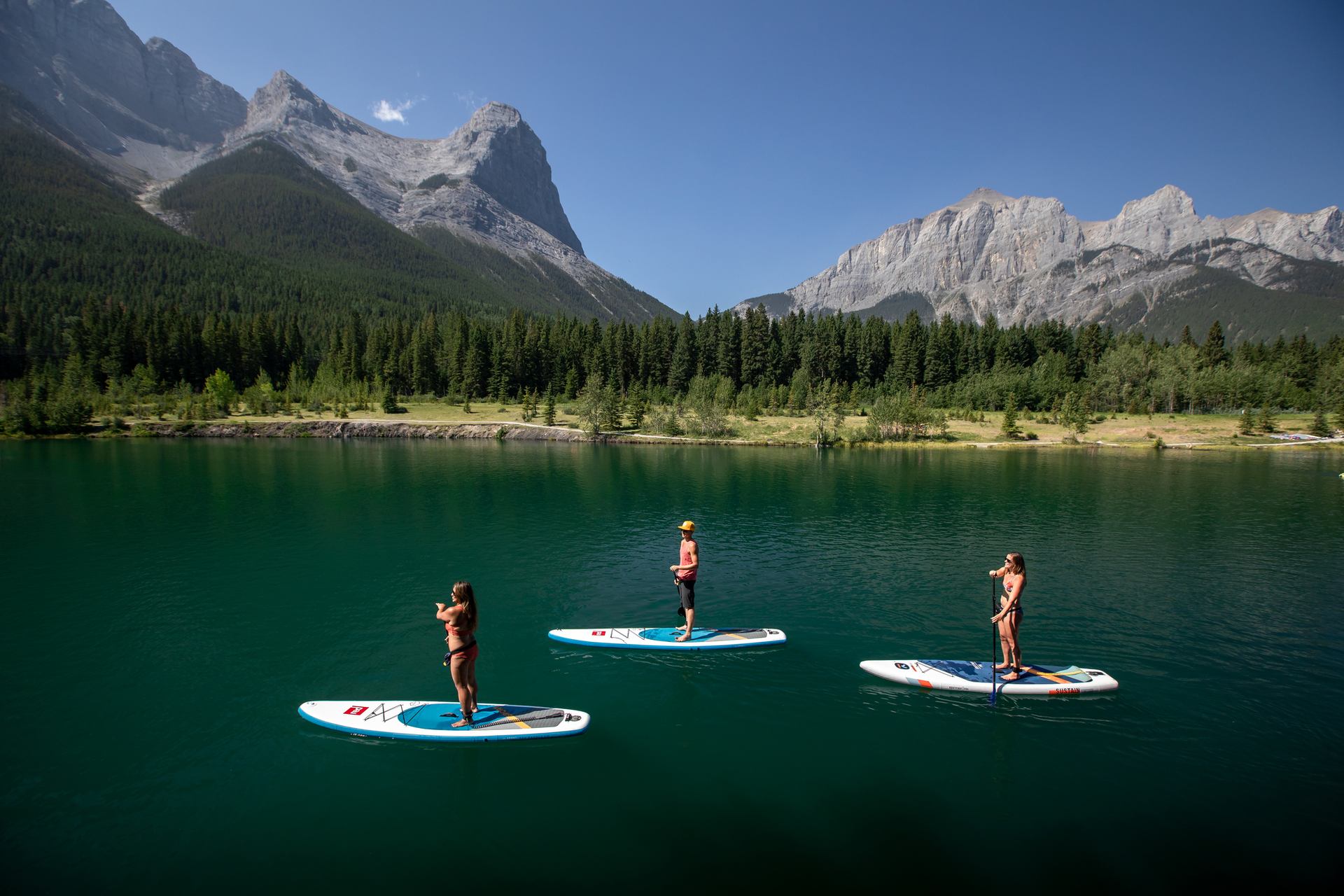 Bow Valley Stand Up Paddleboarding taking a group on a stand-up paddleboarding tour on Quarry Lake.
