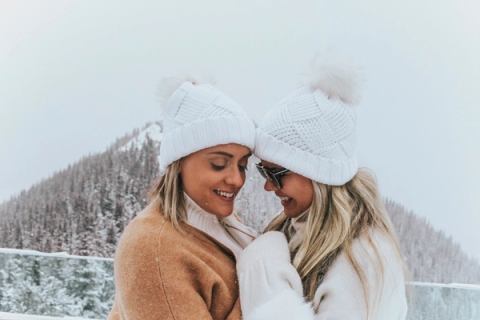 A couple at the Banff Gondola with mountains in the background.