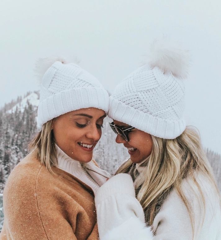 A couple at the Banff Gondola with mountains in the background.