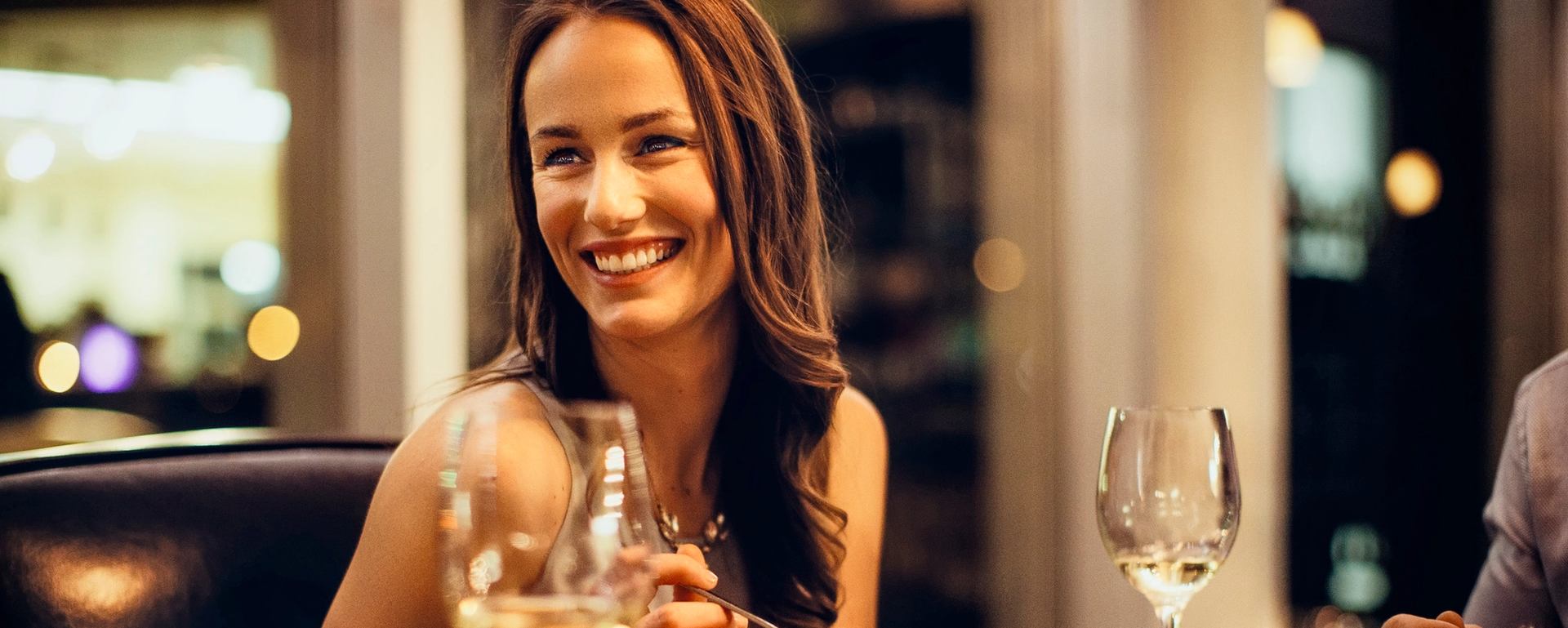 Close-up of a woman dining at Escape Bistro and Wine Bar in Grande Prairie.
