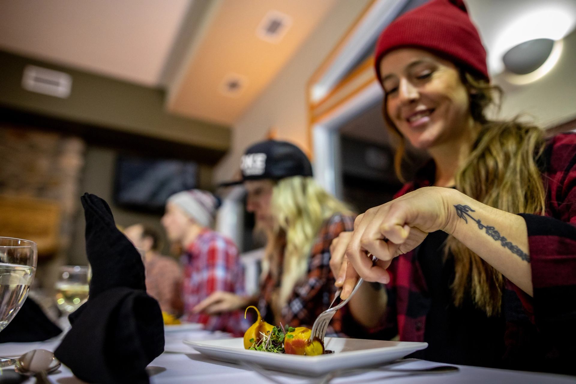 A group of friends enjoy dinner after a day of skiing at Castle Mountain Resort.