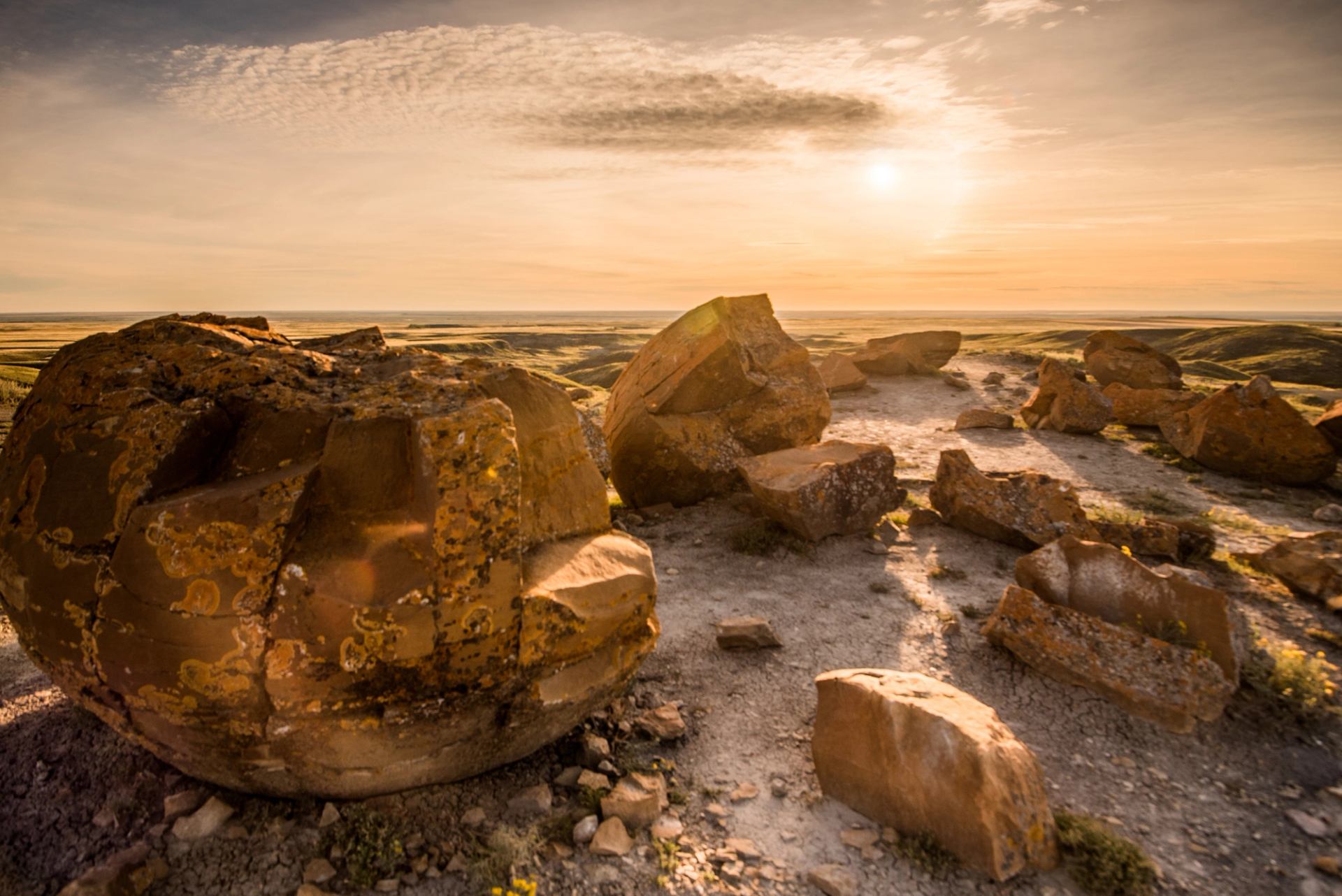 The sun sets on the sandstone boulders at Red Rock Coulee, once covered by prehistoric seas.