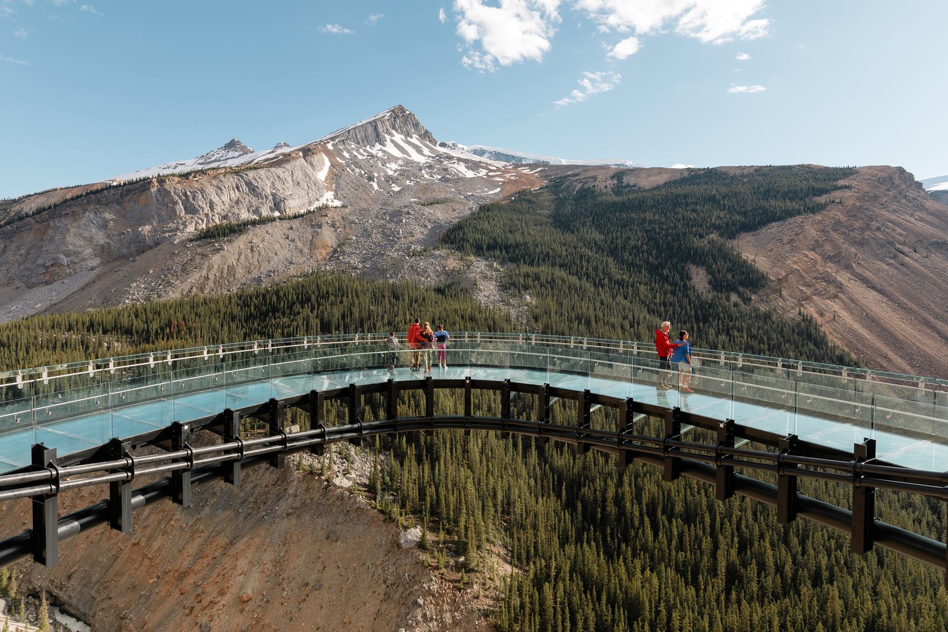 People standing on glass floor glacier skywalk looking onto the Sunwapta Valley in Jasper National Park