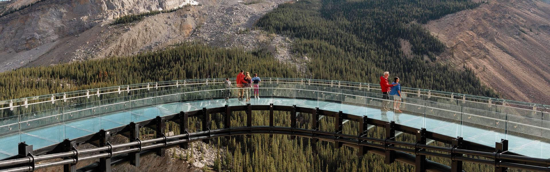 People standing on glass floor glacier skywalk looking onto the Sunwapta Valley in Jasper National Park