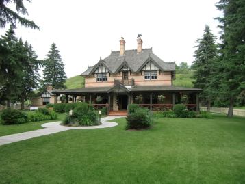 Exterior of historical building turned into a restaurant with a lush garden out front.