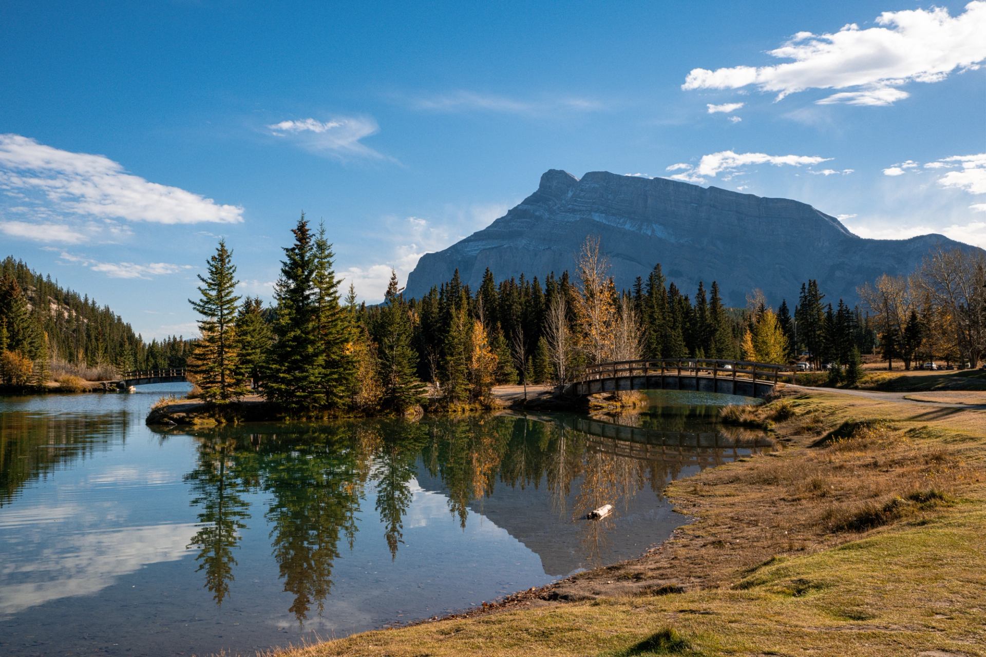 The bridge at Cascade Ponds in Banff National Park with mountains in the background.