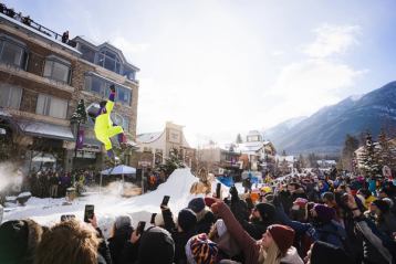 Spectators line the street in Banff, watching skijoring at the SnowDays Festival in Banff