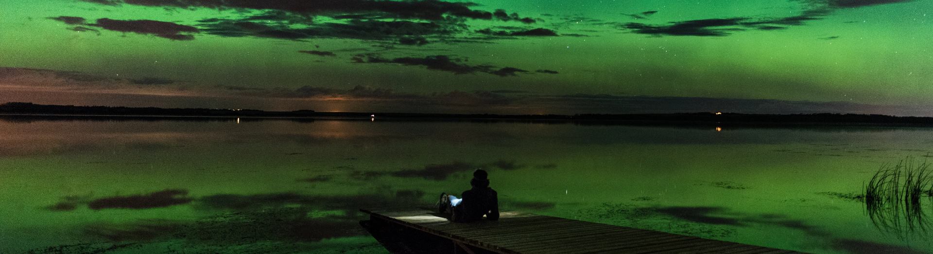 Person looking at the northern lights over Saskatoon Lake