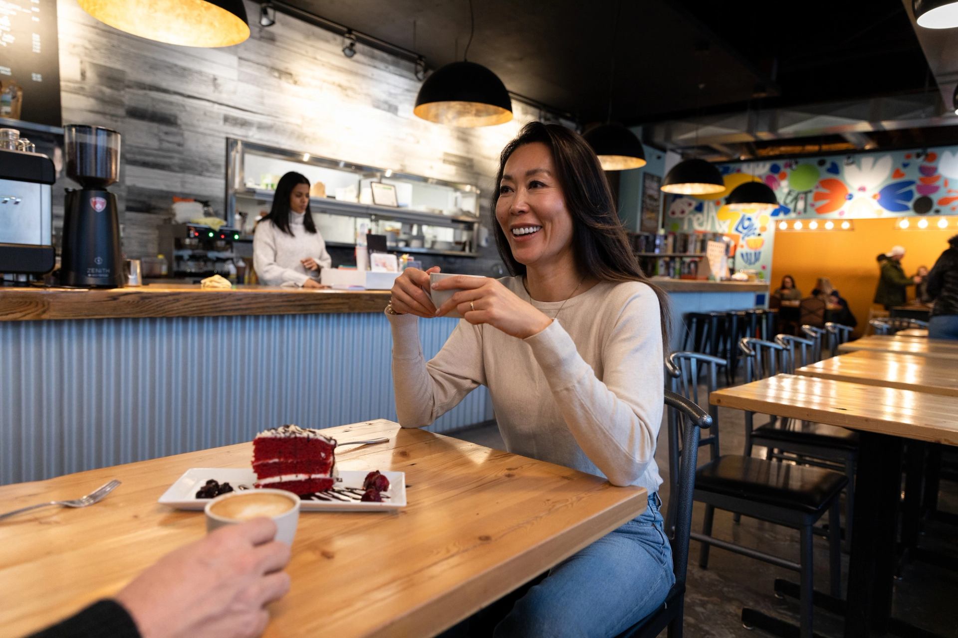 Woman drinking coffee at a cafe in Fort McMurray.