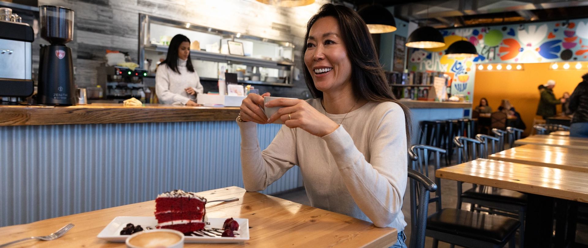 Woman drinking coffee at a cafe in Fort McMurray.