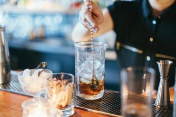 Close-up of a bartender stirring a drink at Woodwork Restaurant in Edmonton