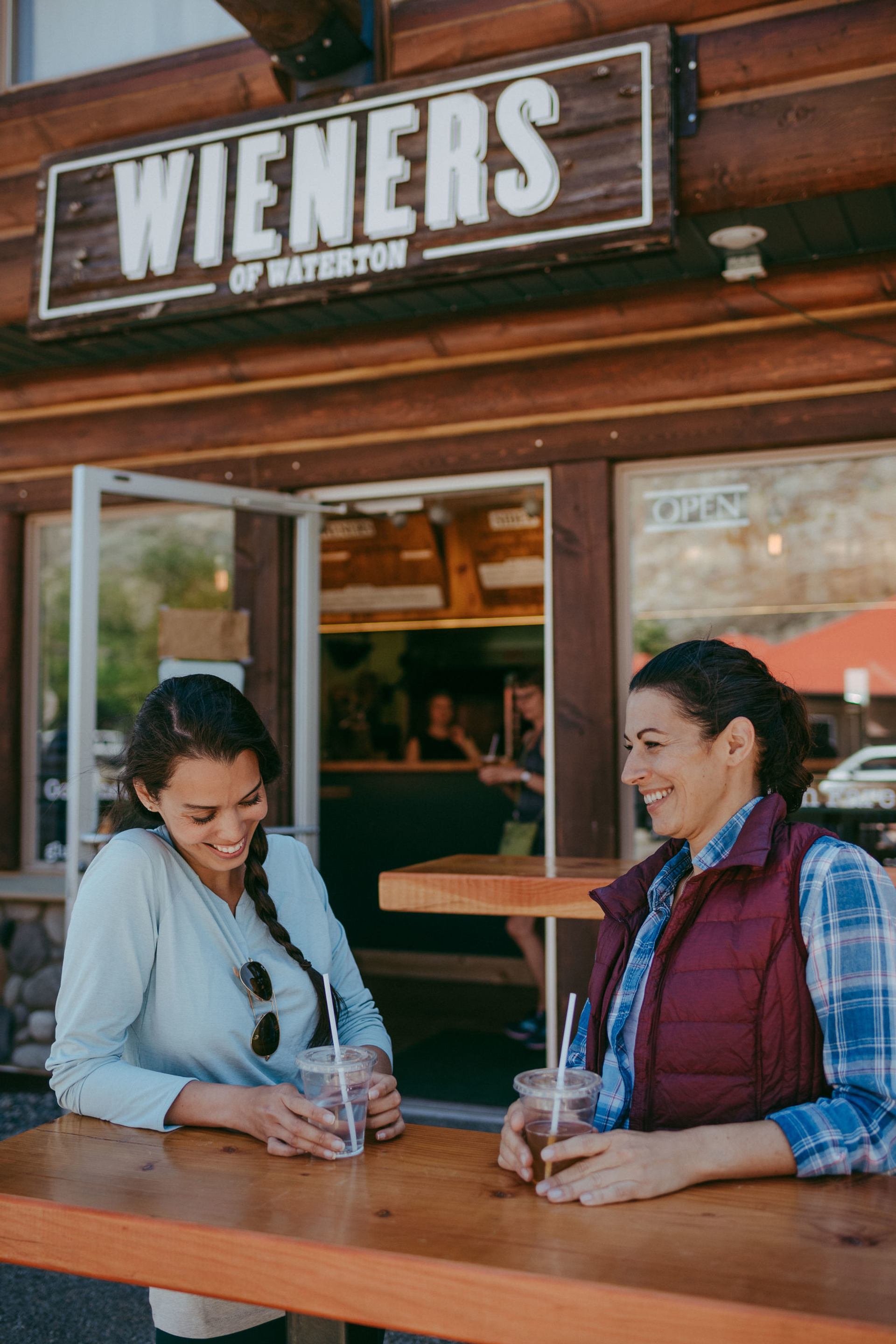 Visitors standing at a table in front of Wieners of Waterton.