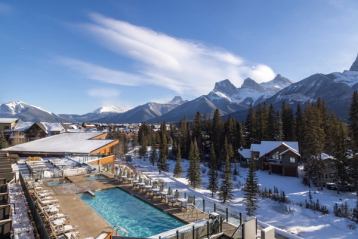 Exterior shot overlooking the Malcom Hotel in Canmore with a great mountain vista.