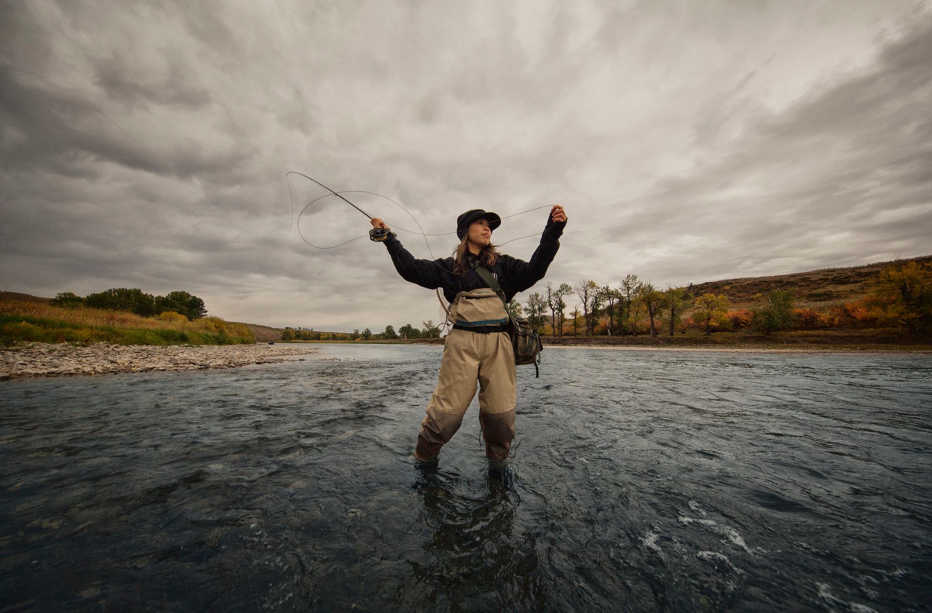 A woman casts her fly finishing line.