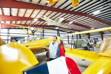 Couple visiting the Bomber Museum - checking out all the aircrafts in Nanton
