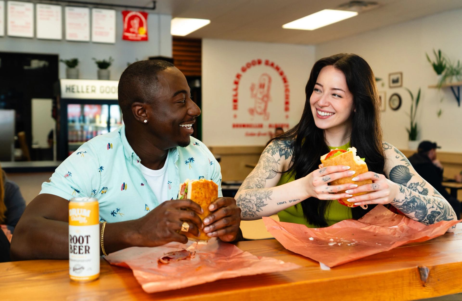 Two people enjoying sandwiches from Heller Good Sandwiches.