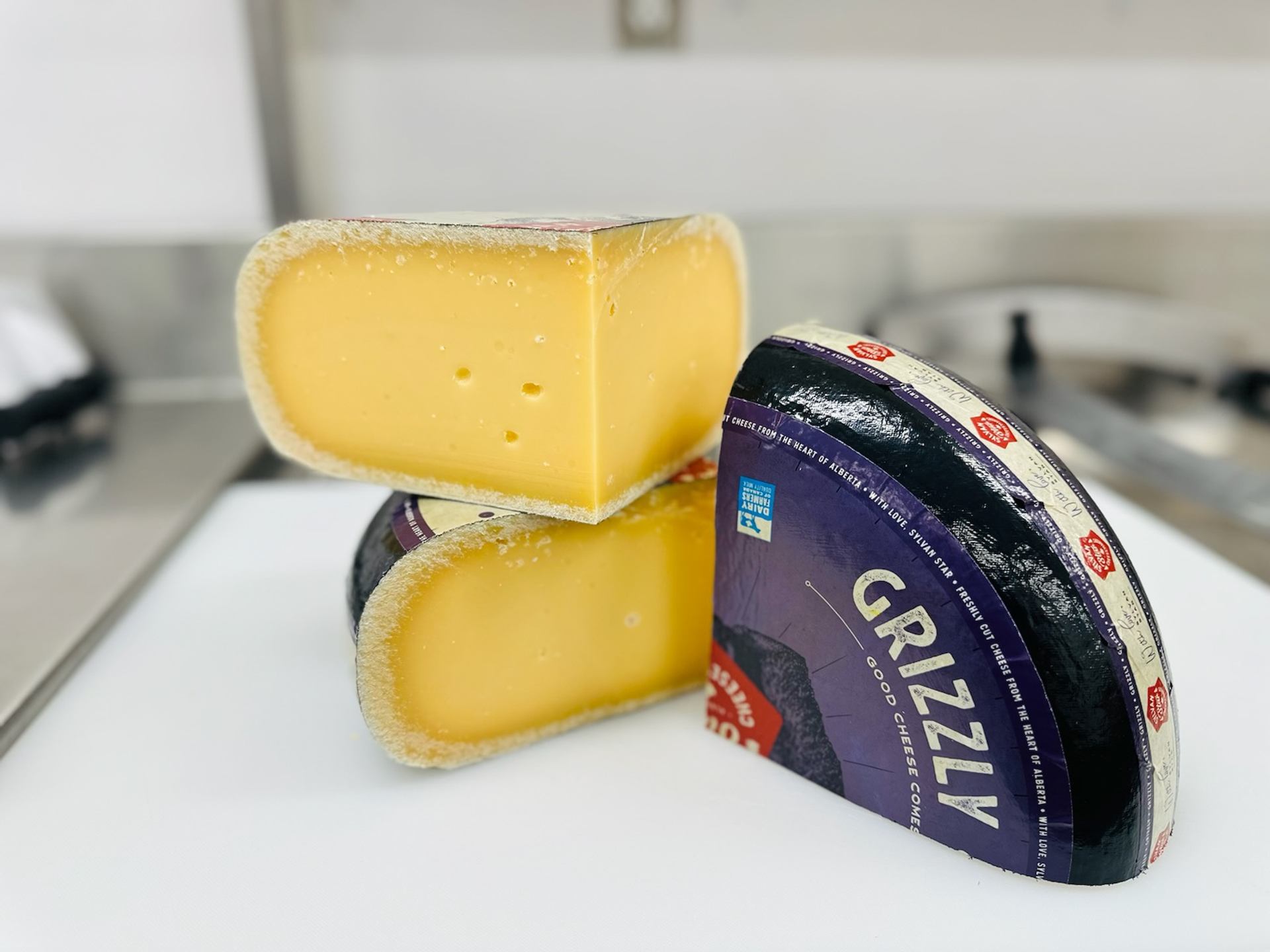 A wheel of Grizzly Gouda from Sylvan Star Cheese is cut into three pieces, showing the layers produced in the aging process.