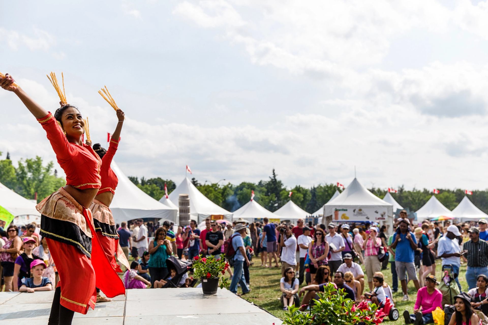 Traditional dancers performing for a crowd at a festival.