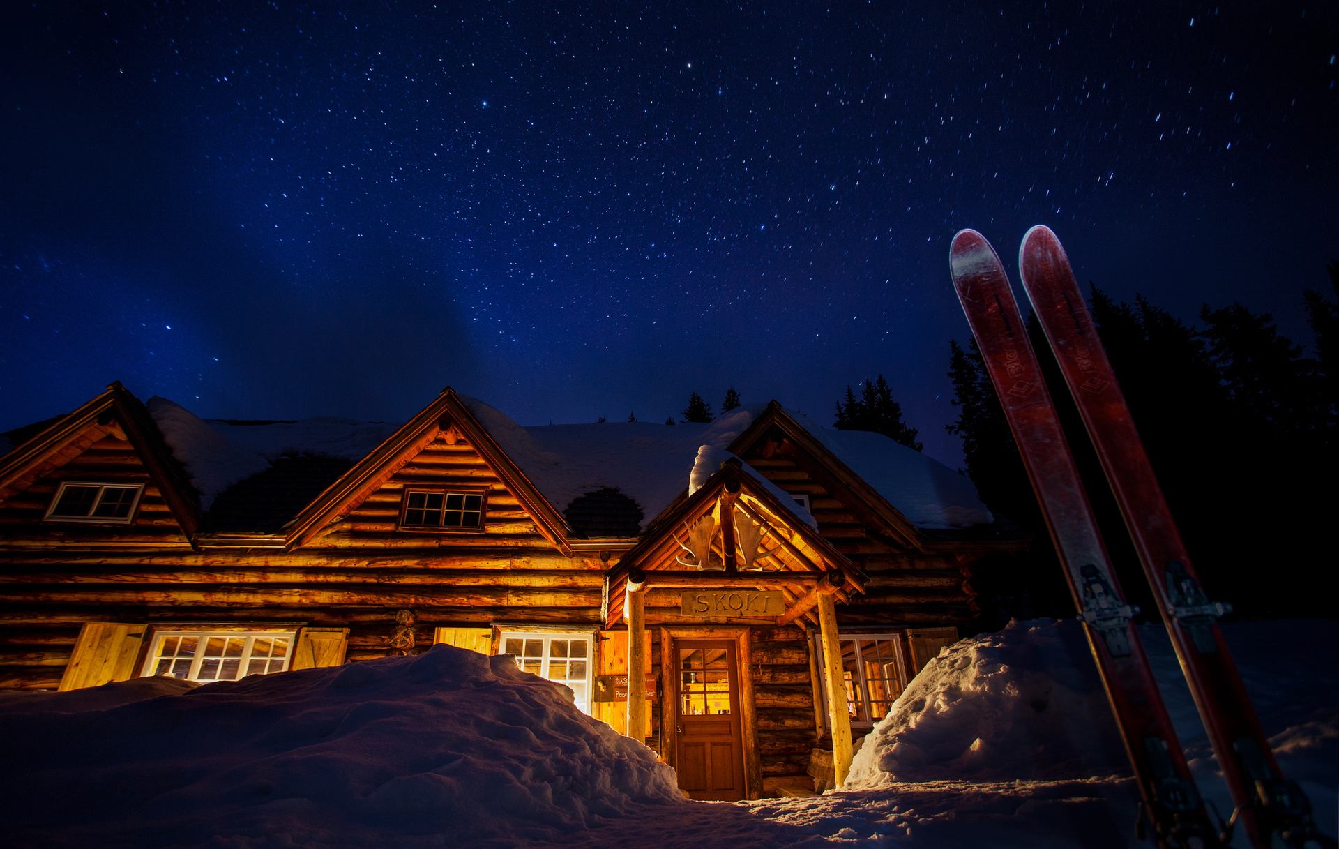 The exterior of Skoki Lodge at night in Banff National Park.