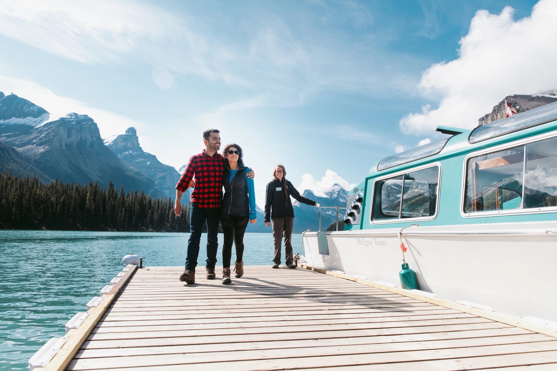 People walking by Spirit Island Maligne Lake Cruise in Jasper.