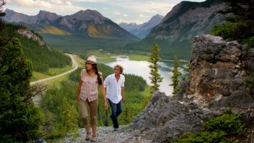 Scenic shot of a couple hiking in Kananaskis above Barrier Lake