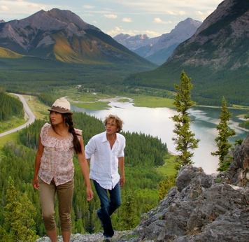 Scenic shot of a couple hiking in Kananaskis above Barrier Lake