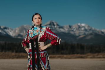 A solo Indigenous women in traditional dress at Stoney Nakoda Resort.