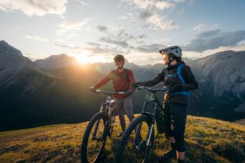 Two mountain bikers rest atop Fortress Mountain.