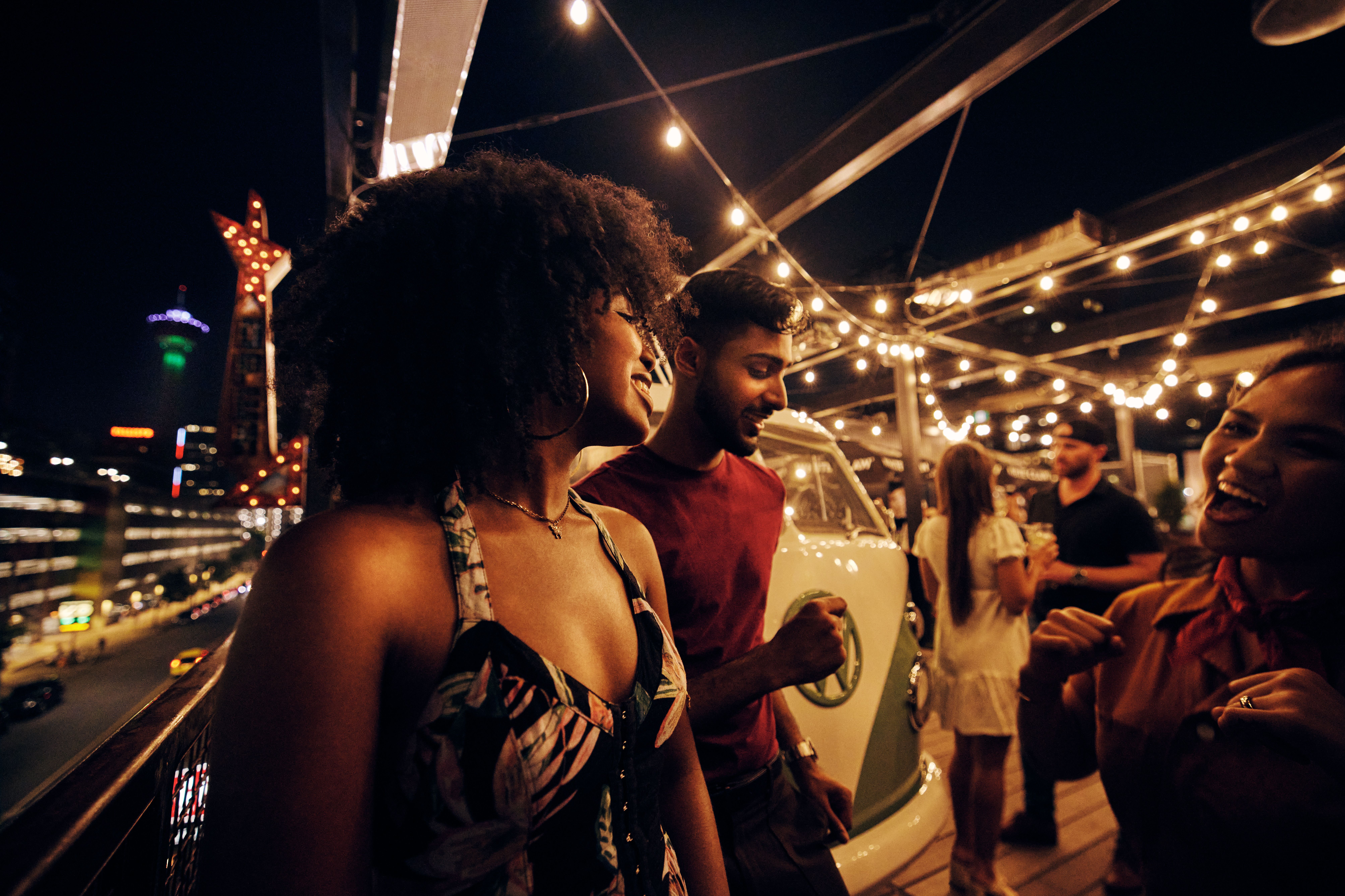 People on rooftop patio at night, in Calgary