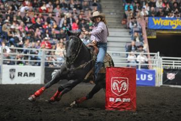 Spectators watch the barrel racing event at the Canadian Finals Rodeo in Edmonton